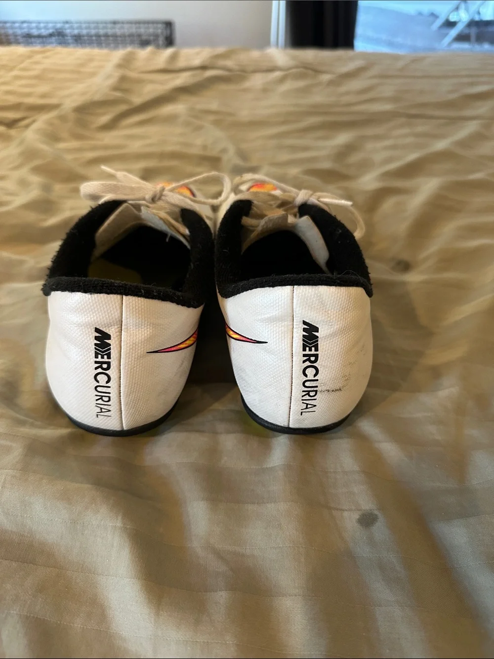Nike Kids White Soccer Cleats with Neon Yellow and Pink Swoosh